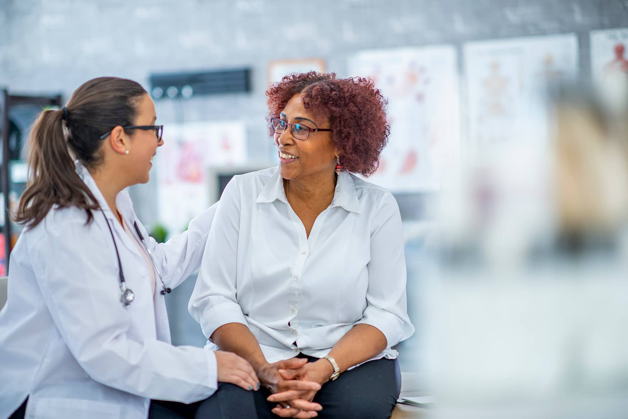 A doctor speaking with a smiling patient